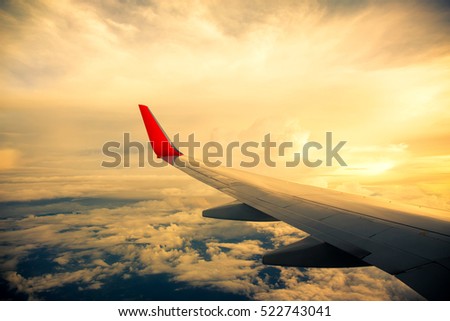 Vintage color of Morning sunrise with Wing of an airplane. Photo applied to tourism operators. picture for add text message or frame website. Traveling concept
