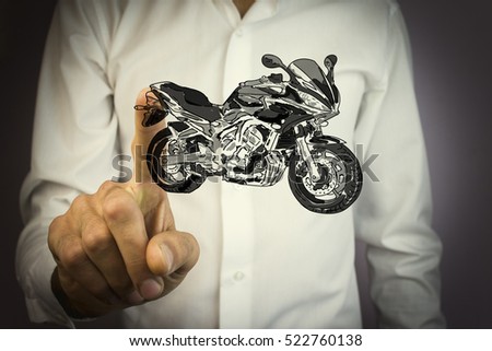 human hands holding the motorcycle
