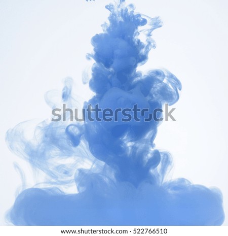 Blue ink petering out in water, white background