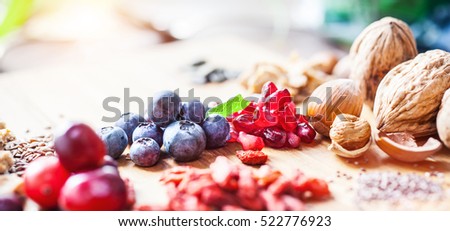 Superfood: Spoons of various healthy superfoods on wooden background Royalty-Free Stock Photo #522776923