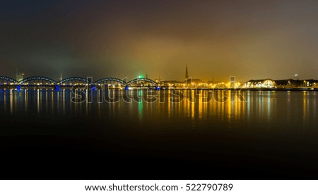 city light reflections over water at the night. Riga, Latvia