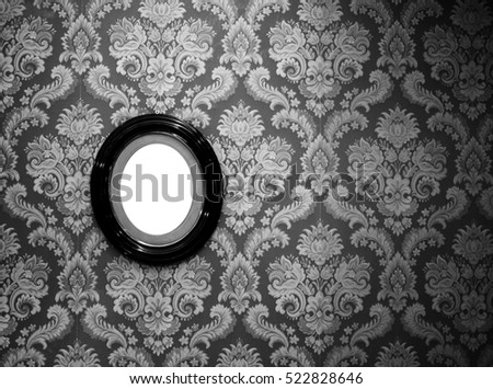 Black and white of oval wall picture frame on classic wallpaper with copy space
