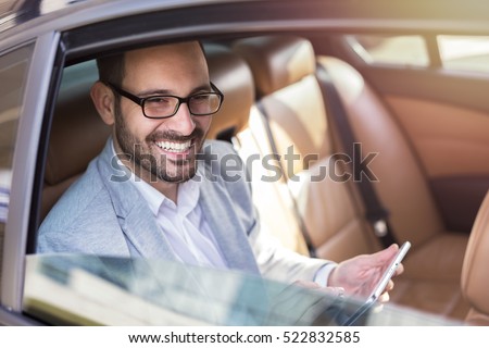 Handsome business man in car.
