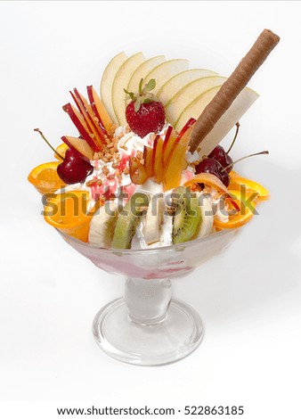 Fresh fruits salad with ice cream in bowl on white background