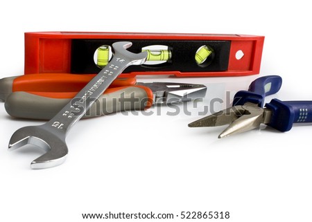 Scattered work tools isolated on white background. Still-life picture taken in studio with soft-box.