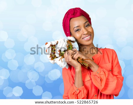 Attractive young black woman holding bouquet of flowers