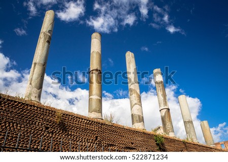 Roman columns of Temple of Venus and Rome against blue sky and clouds, Rome, Italy


