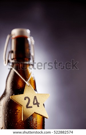 Selective focus view on number 24 in middle of star shape tag around glass bottle bottle used for wine
