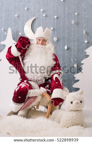 Santa Claus sitting on a sled in Christmas decorations