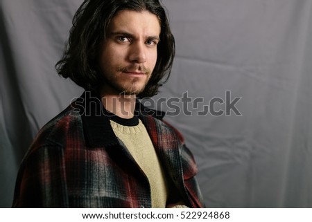 Portrait of a hairy hipster. Young handsome guy posing