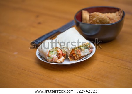 Burrito & Samosas on wooden table