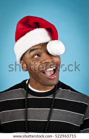 Good looking african american man with santa hat and funny expressions 