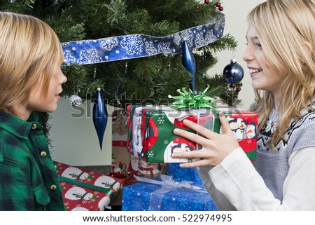 Opening gifts by the christmas tree