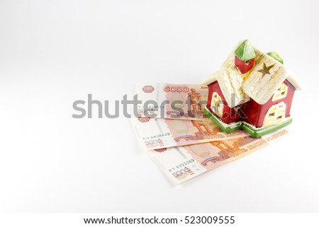House and money on a white background