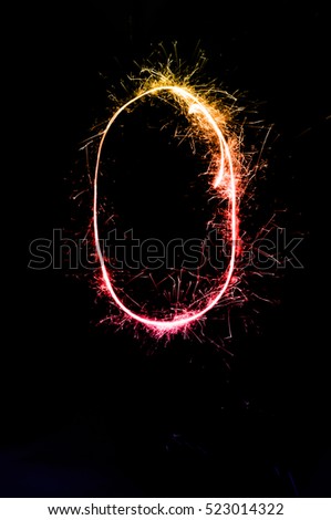"0" number drawn with bengali sparkles isolated on black background,number from sparkler on black background