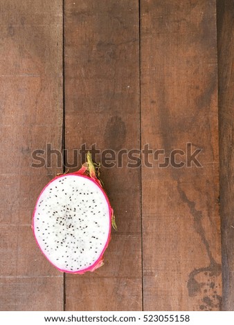 Sliced of Dragon fruit, ripe pitahaya fruit, Pitahaya, Juicy pink pitaya on the top of wooden table with natural light.