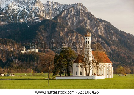 St. Coloman Church in Southern Germany, in back famous Neuschwanstein Castle in spring time