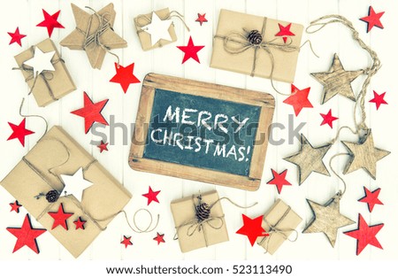 Wrapped gifts with christmas decoration and chalkboard. Merry Christmas! Vintage style toned picture