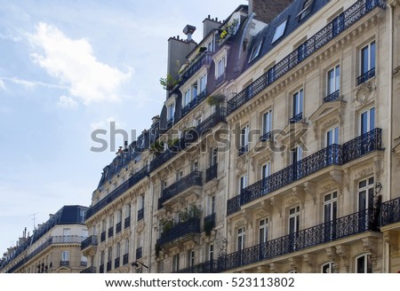 Buildings at 2nd arrondissement in Paris showing 19th century architectural style. Iron, ornamental balconies and plants are in the view.