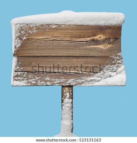 Wooden signpost with snow on it isolated on blue