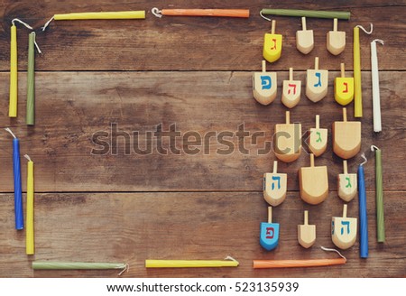 Image of jewish holiday Hanukkah with wooden dreidel (spinning top)