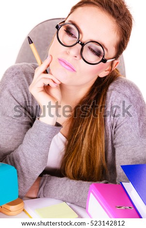 Woman working in office. Businesswoman or secretary with many documents folders bills on her desk taking break, relaxing at work thinking day dreaming. Studio shot on white