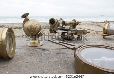 Natural background with a compass , a telescope, a sextant and an hourglass and texture of old wood