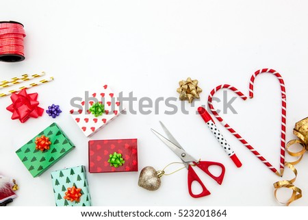 christmas gifts, scissors, pencil, candy cane, straws, ornament in white background