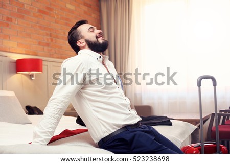Picture showing tired businessman relaxing in hotel room