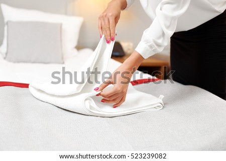 Picture of maid folding fresh towels in hotel room