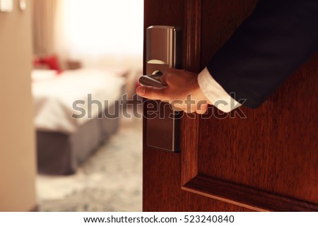 Picture showing hand of businessman opening hotel room