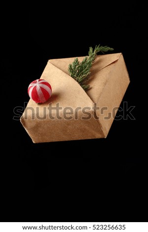 Wrapped vintage gift box with red ribbon bow, isolated on black