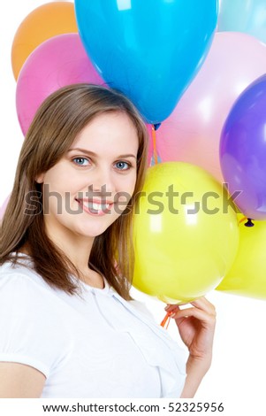 Pretty young woman holding balloons and looking at camera