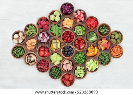 Super food for paleolithic diet in wooden bowls over distressed white wood background. High in vitamins, antioxidants, minerals and anthocyanins. Royalty-Free Stock Photo #523268890