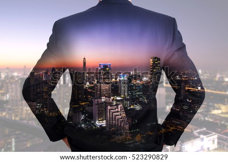 A back turned businessman, cityscape, urban and street in the night as vision of leader concept. Royalty-Free Stock Photo #523290829