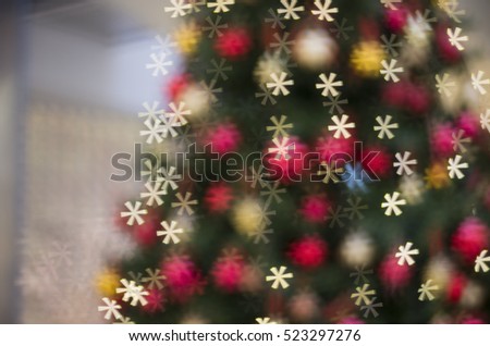 Blurring background Christmas and New Year Nativity tree with bokeh in the form of snowflakes