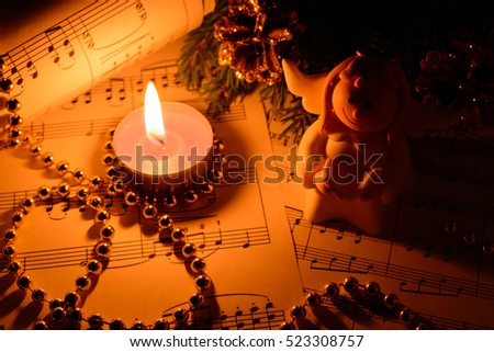 Christmas decorations, candles, figures of angels and notes in the dark