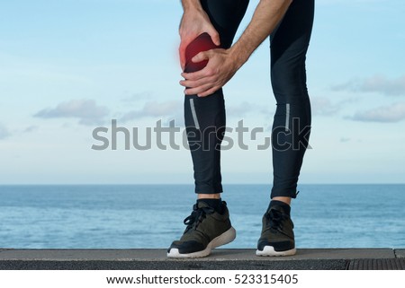 Pain in knee injury of sportsman Royalty-Free Stock Photo #523315405