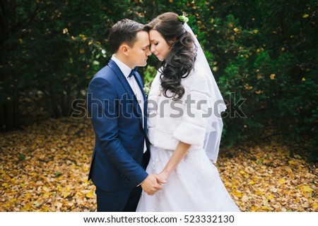 Wedding photo shoot. Beautiful groom and bride in nature
