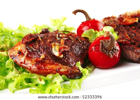served roast beef steak on white plate with salad