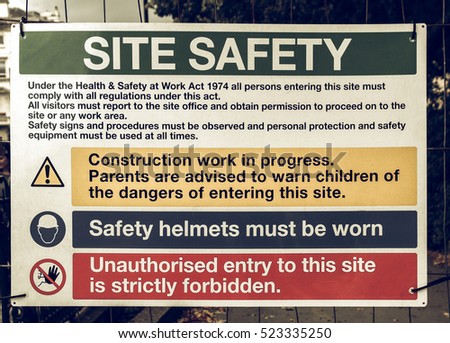 Vintage looking Safety sign in a construction site with work in progress