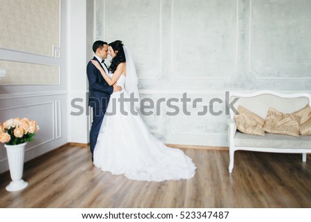 Wedding photo shoot of the newlyweds in a beautiful Studio interior 
 Royalty-Free Stock Photo #523347487