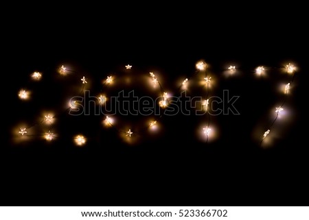 Number 2017.Christmas light, star shaped on dark background Royalty-Free Stock Photo #523366702