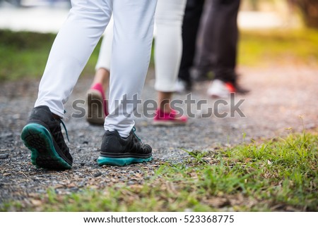 group of people wear sport shoes walking, running, traveling, hiking or exercise together outdoors workout in the park, close up of feet. Royalty-Free Stock Photo #523368775