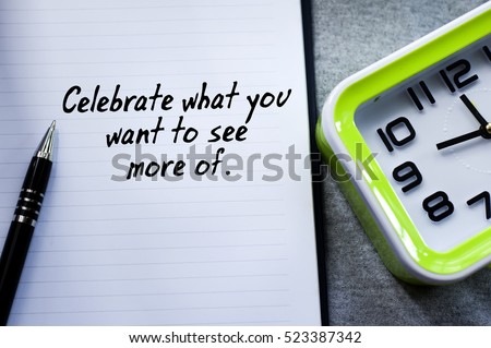 A new year motivational quotes in the background of pen, book and green desk clock. Conceptual of business, education, finance, news.