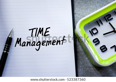 A new year motivational quotes in the background of pen, book and green desk clock. Conceptual of business, education, finance, news.