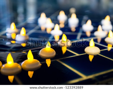 bright candle float on water in night 
