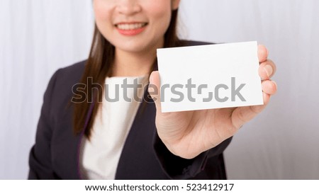 Businesswoman holding a blank card,focus blank card.
