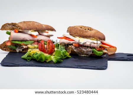sandwich with ham, brie cheese, vegetables