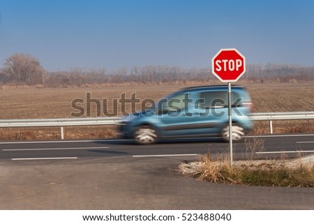 Stop Sign at Crossroads. Rural road. Exit onto the main road. Main road. Dangerous road. Traffic signs stop.
